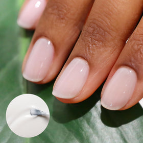 Manucurist brush close-up spreading polish smoothly for streak-free application