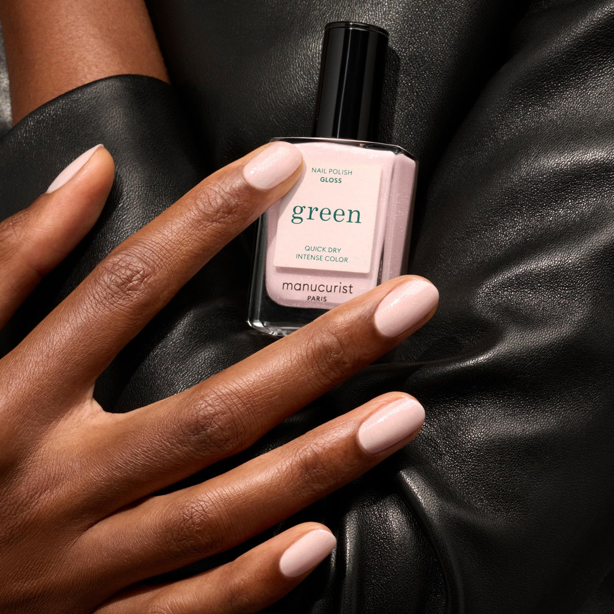 Hand wearing Manucurist iridescent white showing luminous pink reflections