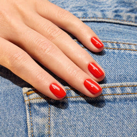 Manucurist color swatch on a nail wheel showing true orangey-red shade accuracy