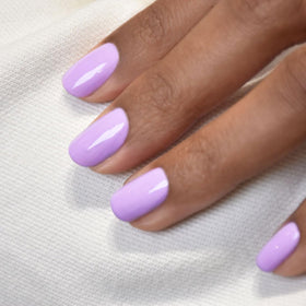 manucurist swatch on nail tip displaying opaque lilac finish and glossy shine