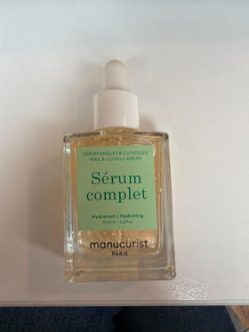 Hand next to Manucurist bottles to show product size and everyday use