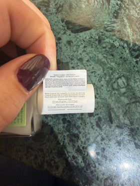 Manucurist bottle beside hand for scale showing compact, travel-friendly benefit
