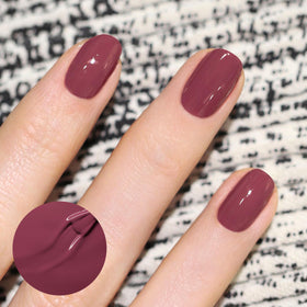 Manucurist painted fingernails in Victoria Plum showing opaque finish and wearable shade benefit