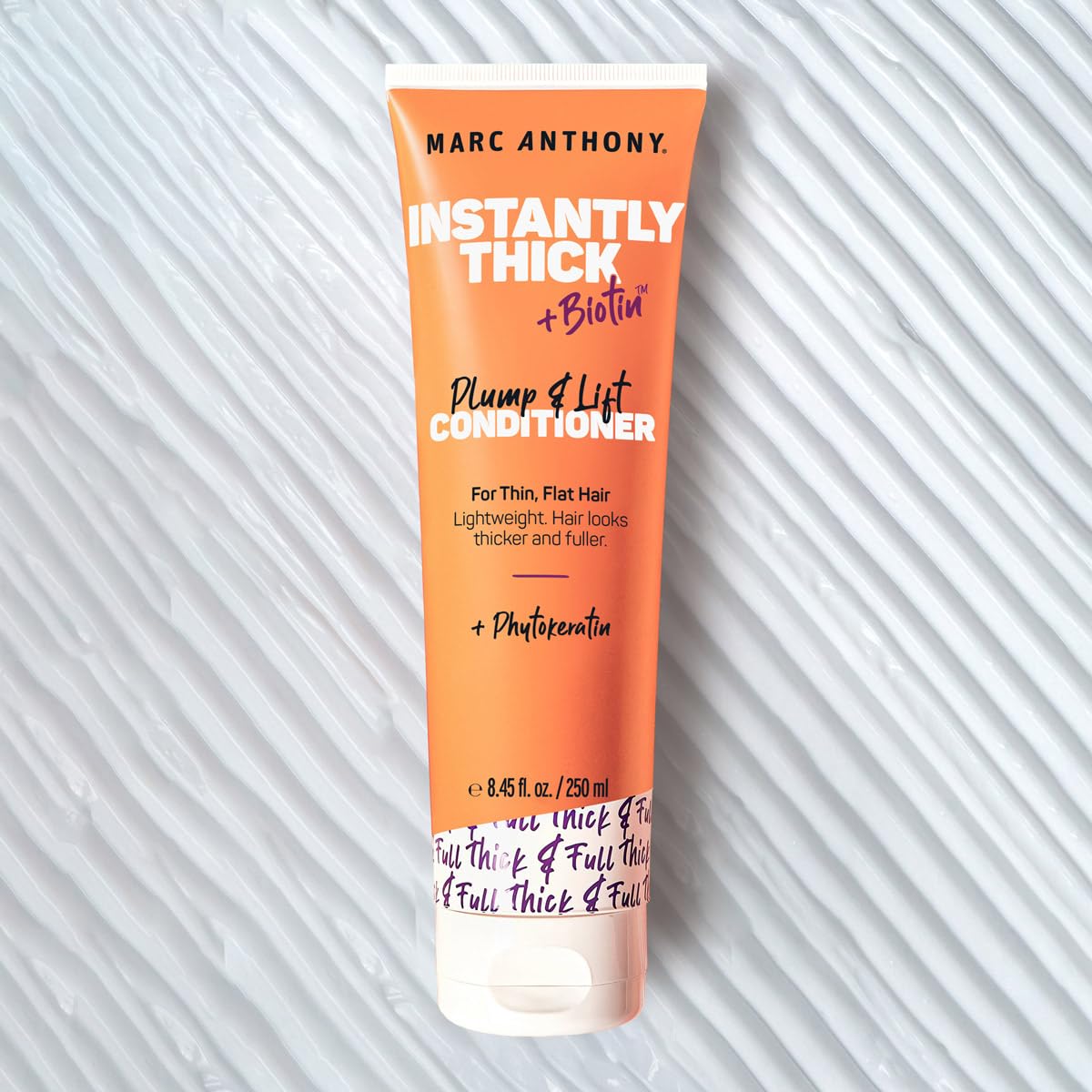 Marc Anthony creamy texture on palm showing lightweight conditioner for smooth slip