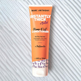 Marc Anthony creamy texture on palm showing lightweight conditioner for smooth slip