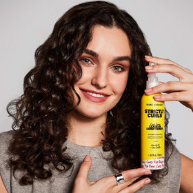Marc Anthony lifestyle curly hair model showing hydrated, defined curls and natural bounce