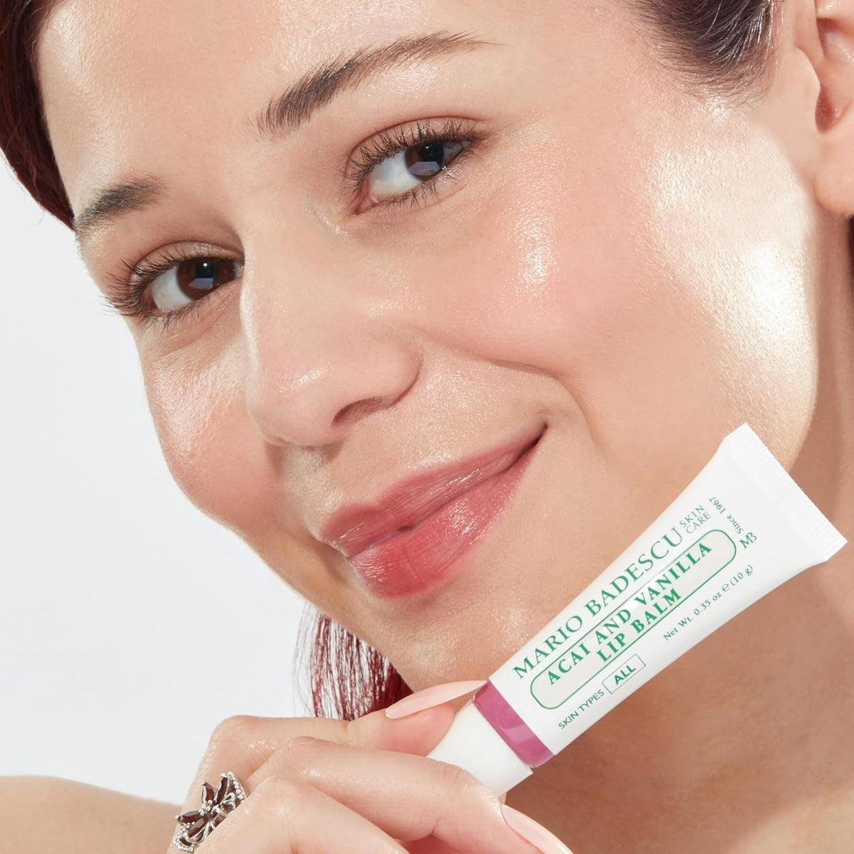 Mario Badescu balm being applied outdoors to soothe lips after wind exposure