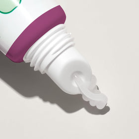 Mario Badescu tube next to a coin to show travel-friendly, pocket-sized convenience