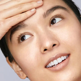 Mario Badescu cleansing oil shown on fingertips to illustrate effortless makeup removal