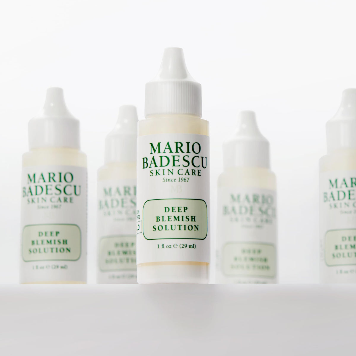 Mario Badescu applied to cheek spot to soothe and reduce deep blemish visibility