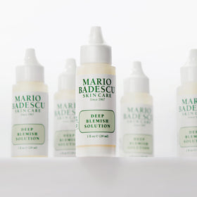 Mario Badescu applied to cheek spot to soothe and reduce deep blemish visibility