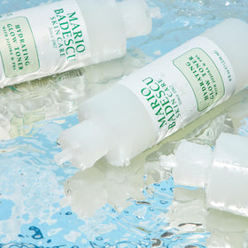 Mario Badescu bottle beside red algae to emphasize nourishing extract benefit
