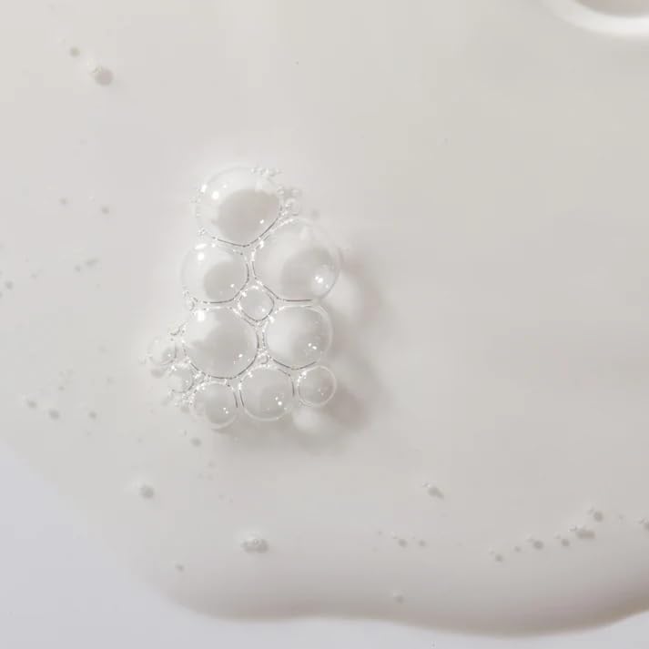 Mario Badescu serum on hand scale demonstrating 1 fl oz size and easy dosing