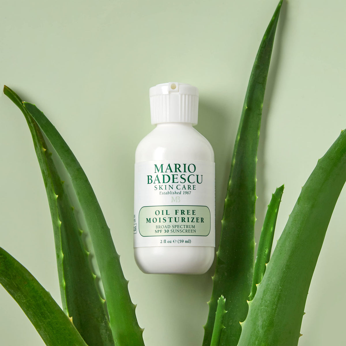 Mario Badescu tube beside a coin illustrating portable 2 fl oz convenience