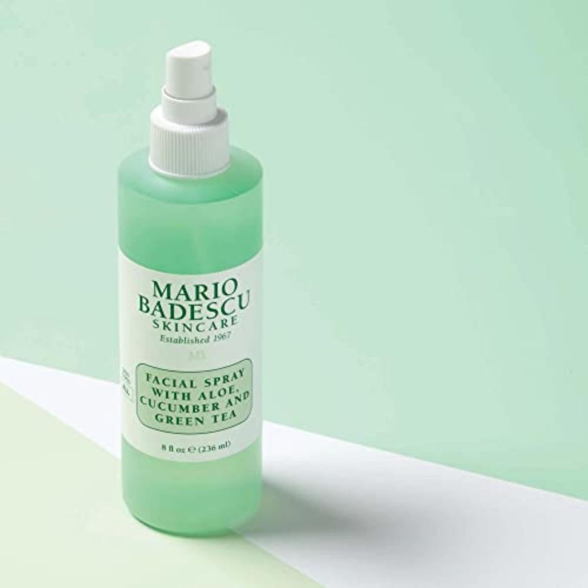 Mario Badescu bottle held in hand for scale demonstrating convenient 8 fl oz size