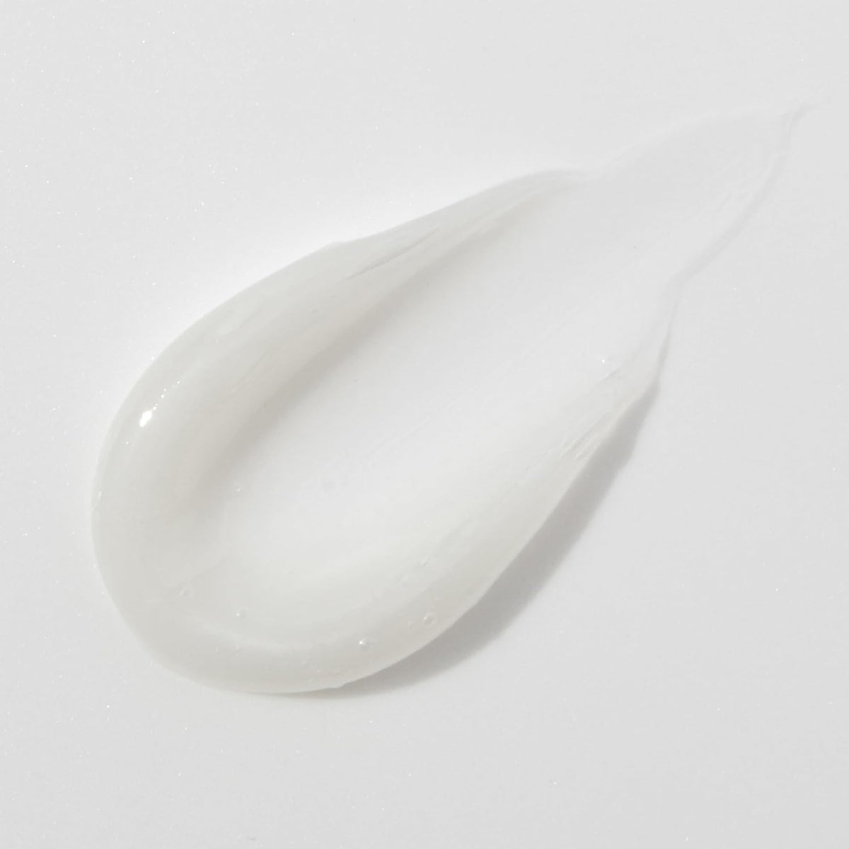 Mario Badescu tube next to a phone illustrating pocket-sized convenience benefit