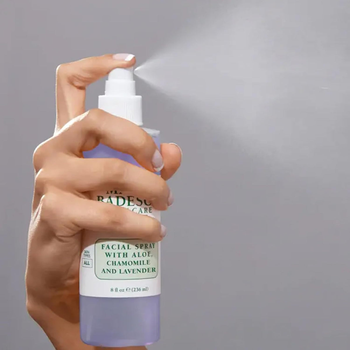 Mario Badescu size scale in hand showing 4 fl oz travel friendly bottles