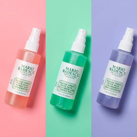 Mario Badescu bottles next to hand showing travel-friendly size