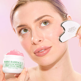 Mario Badescu jar held in hand for scale showing convenient travel-friendly size
