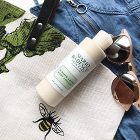 Mario Badescu product on collarbones producing subtle candlelit sheen