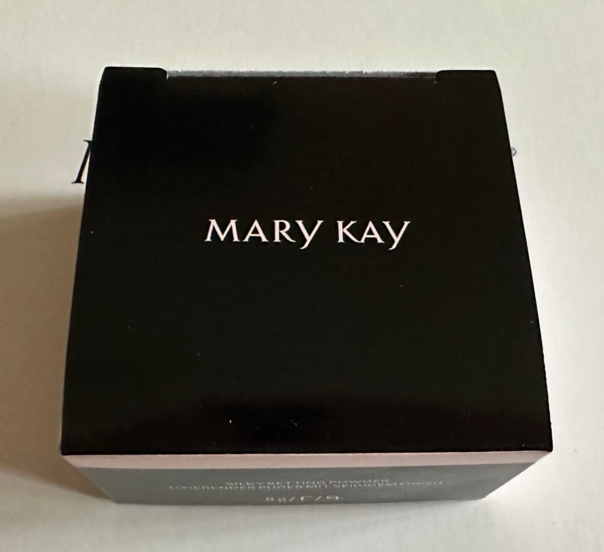 Mary Kay powder being applied with brush for smooth, natural setting