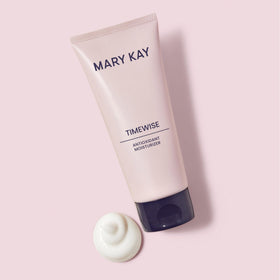 Person applying Mary Kay TimeWise moisturizer to face for smooth finish