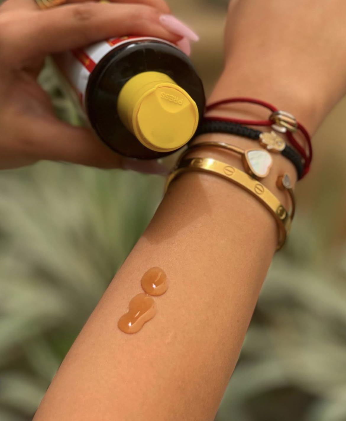 Applying Maui Island Secret on forearm to accelerate tanning and moisturize skin