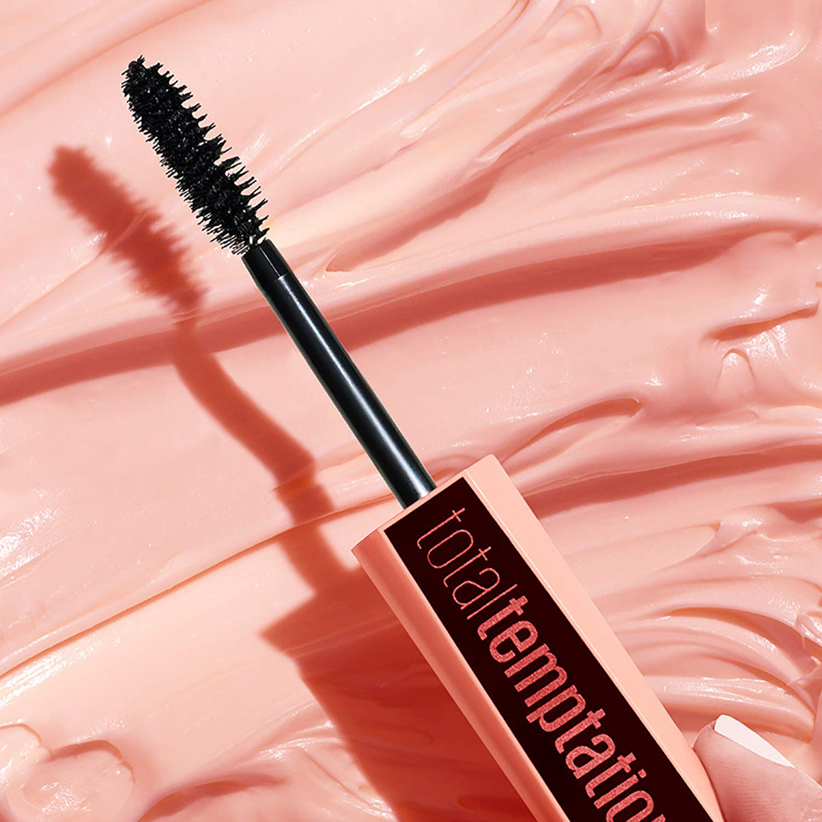 Maybelline product placed next to ruler displays 0.27 fl. oz. scale for travel-friendly convenience