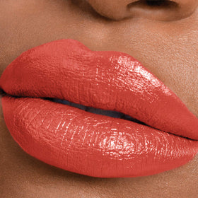 MAYBELLINE tube beside coin demonstrating compact size and travel-friendly benefit