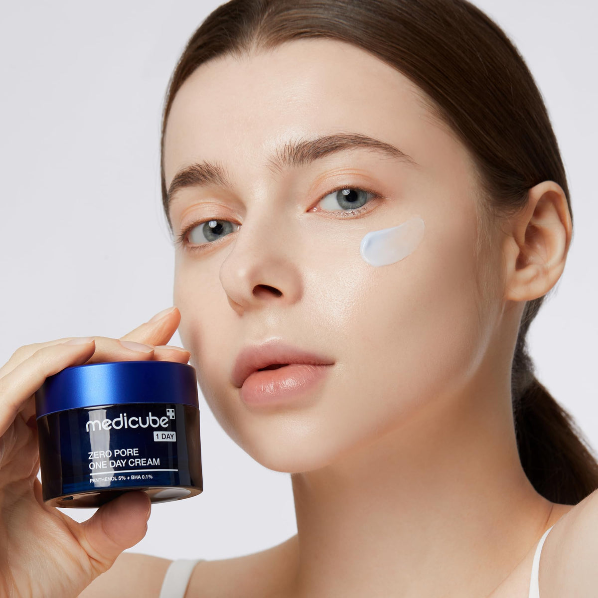Medicube jar opened showing product inside for visible smooth cream