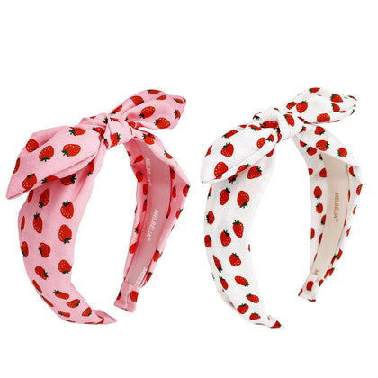 Melbelia front packaging showing two red and white headbands and benefits