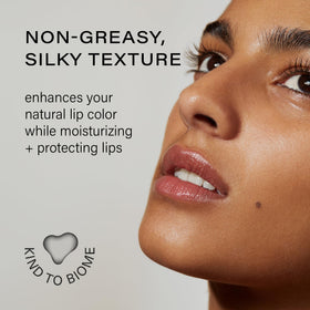 Melixir lip butter held in hand to show size and travel-friendly convenience benefit