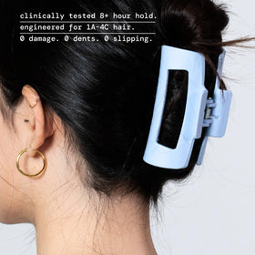 MELLO clip flexed flat against headrest showing compression benefit