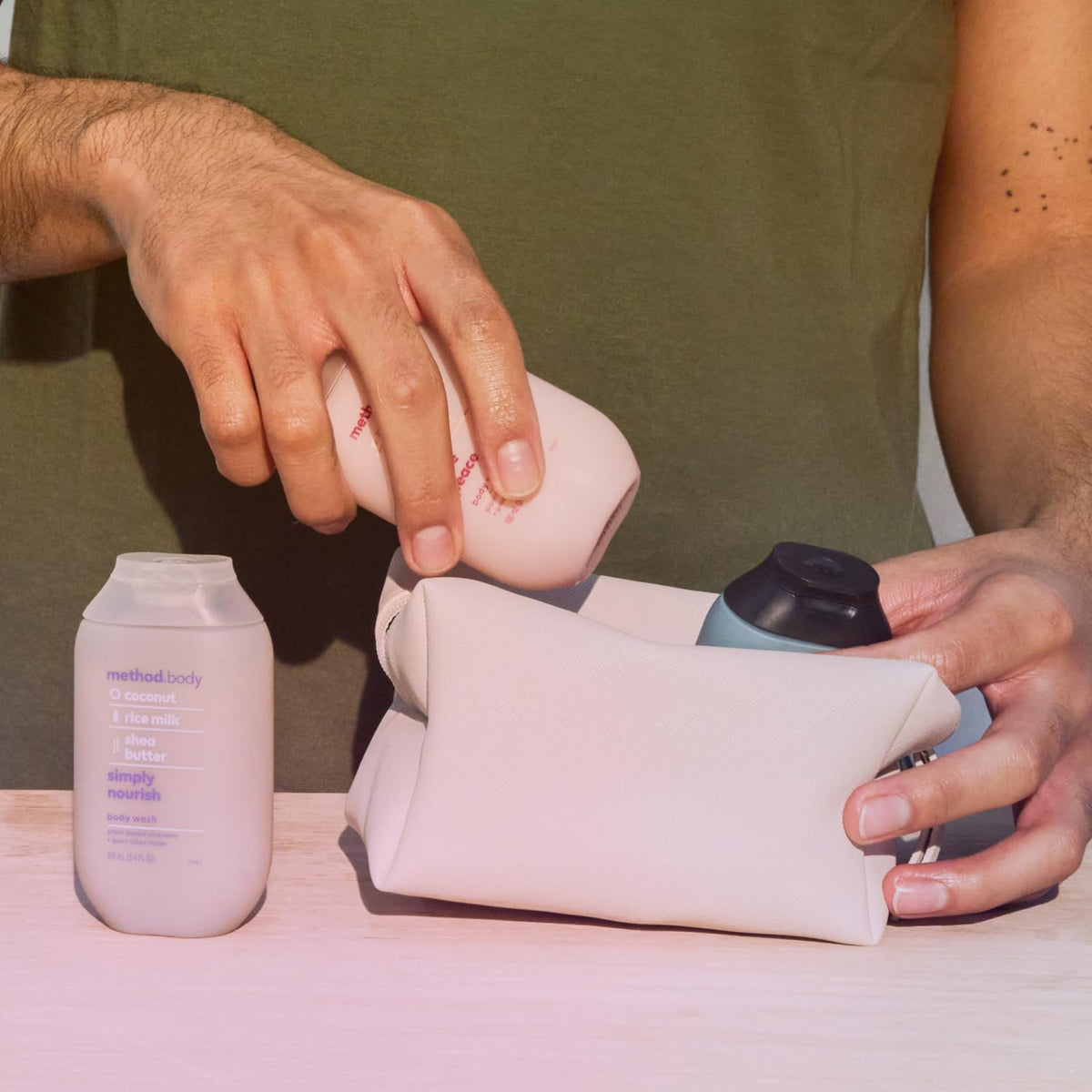 Method bottle held in hand showing 3.4 oz scale for easy packing