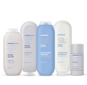 Method bottle next to hand to show 13.5 fl oz size and travel practicality