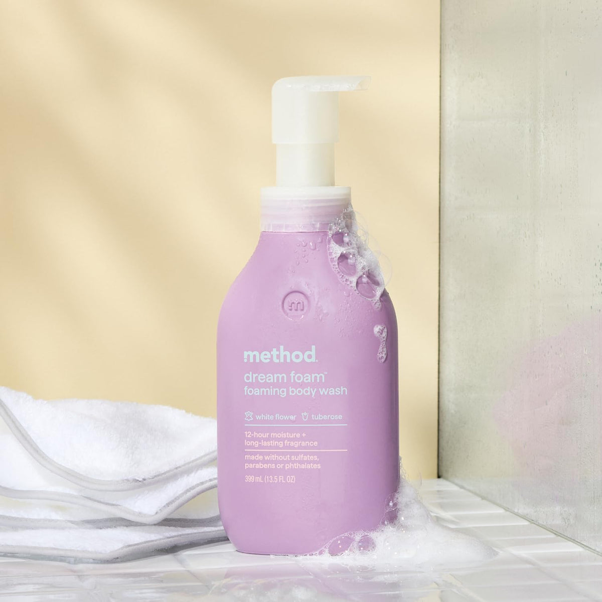 Method Dream Foam held in hand for scale, conveys travel-friendly 13.5 oz