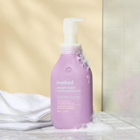 Method Dream Foam held in hand for scale, conveys travel-friendly 13.5 oz