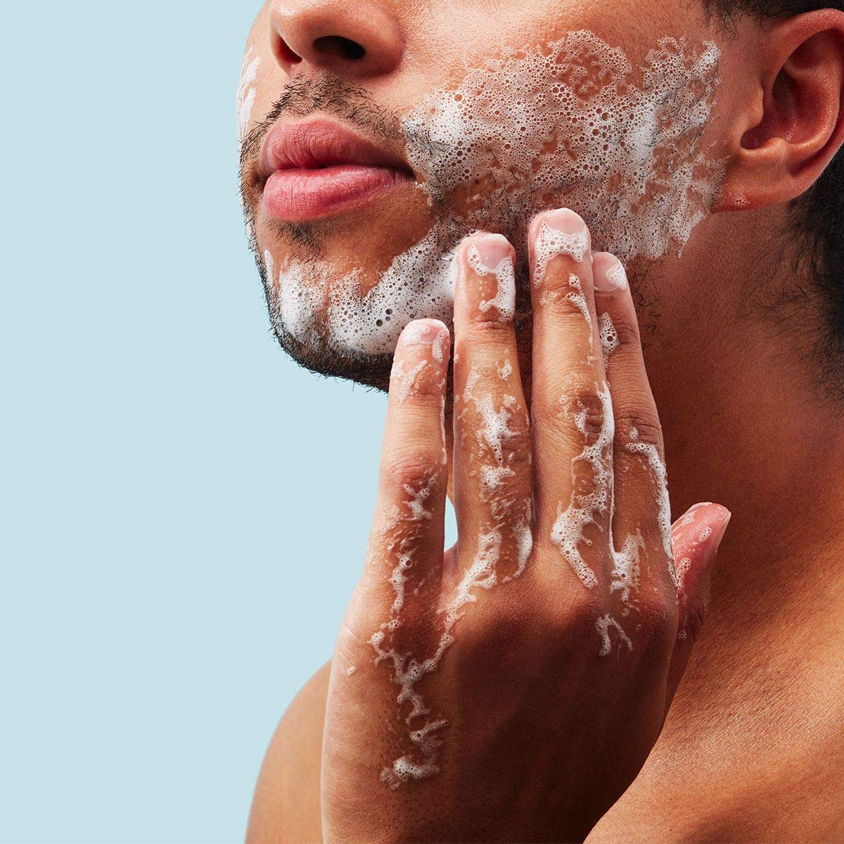 Method men face wash bottle in hand to show 6 ounce size and travel-friendly scale