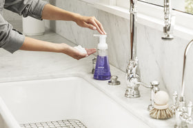 Method bottle held by hand for size comparison, showing portable 10 fl oz convenience