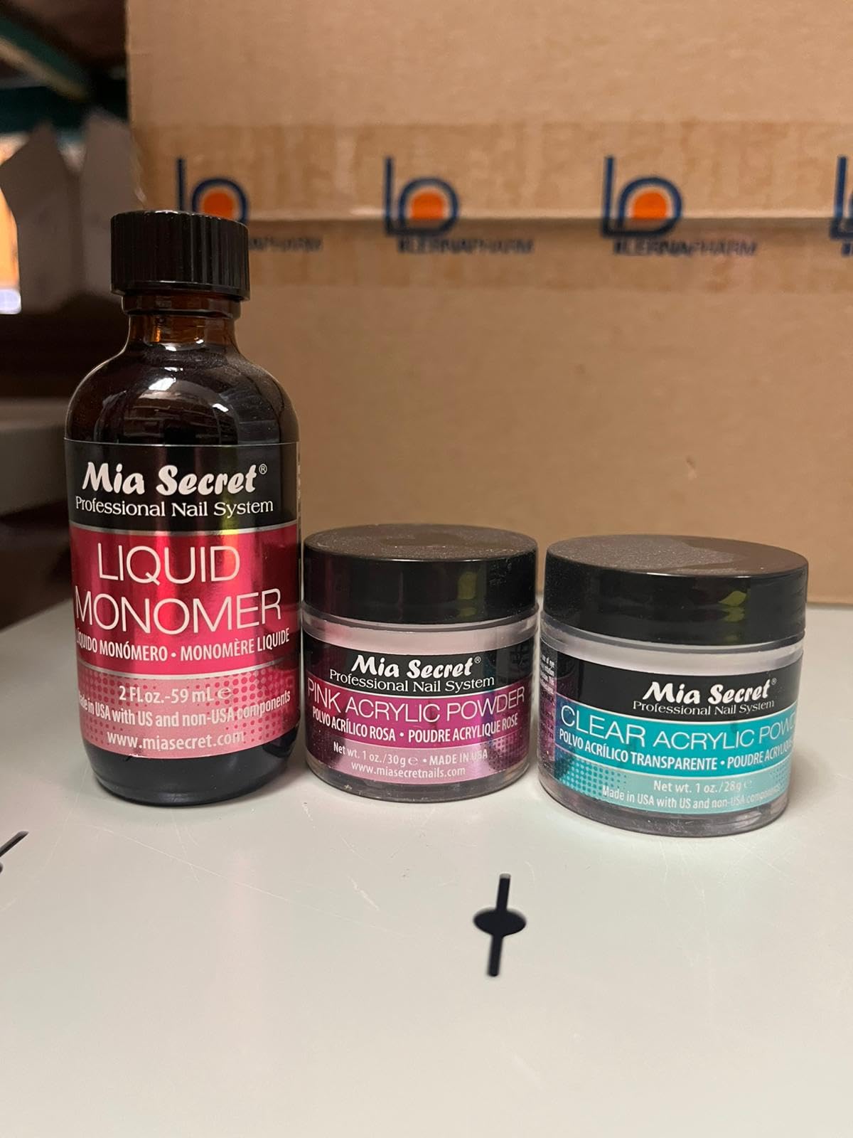 Mia Secret 2oz liquid monomer bottle close-up, highlighting pour spout for controlled use