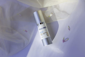 MiamiMD dabbing serum on cheek illustrating gentle use and even tone benefit