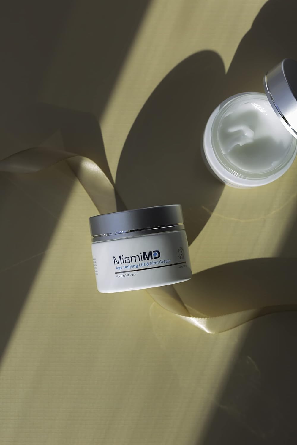 MiamiMD jar on bathroom shelf at night suggesting nightly firming routine