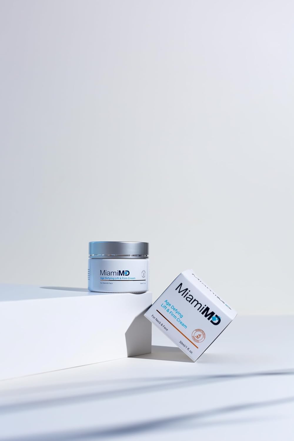 MiamiMD cream next to a hand showing 50 ml size for accurate scale