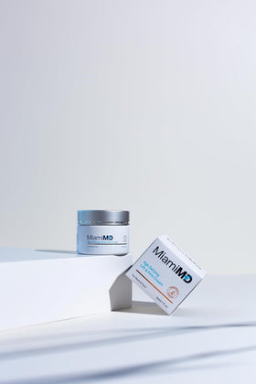 MiamiMD cream next to a hand showing 50 ml size for accurate scale