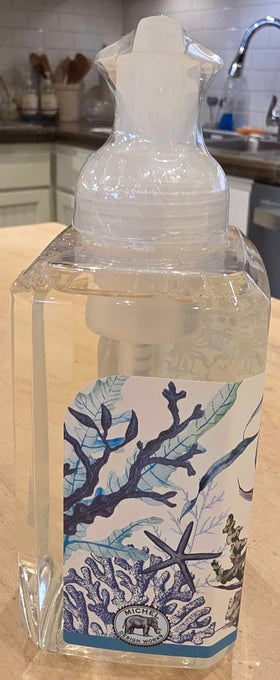 Michel Design Works bottle held by hand to show size and convenient countertop scale