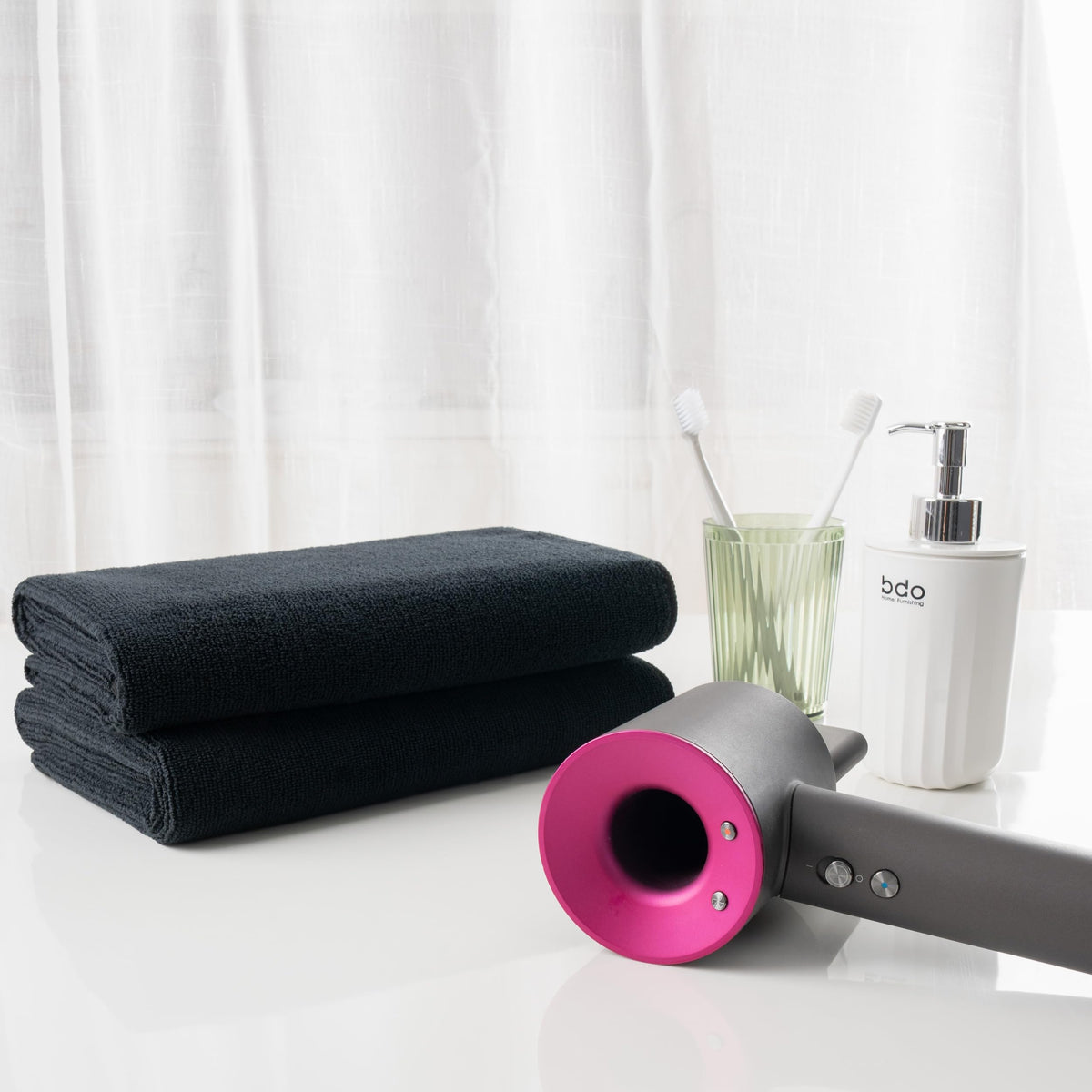 MICROFI towel next to a chair showing generous size and real-world scale