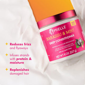 Mielle Organics being applied to curly hair, demonstrating hydration and improved manageability