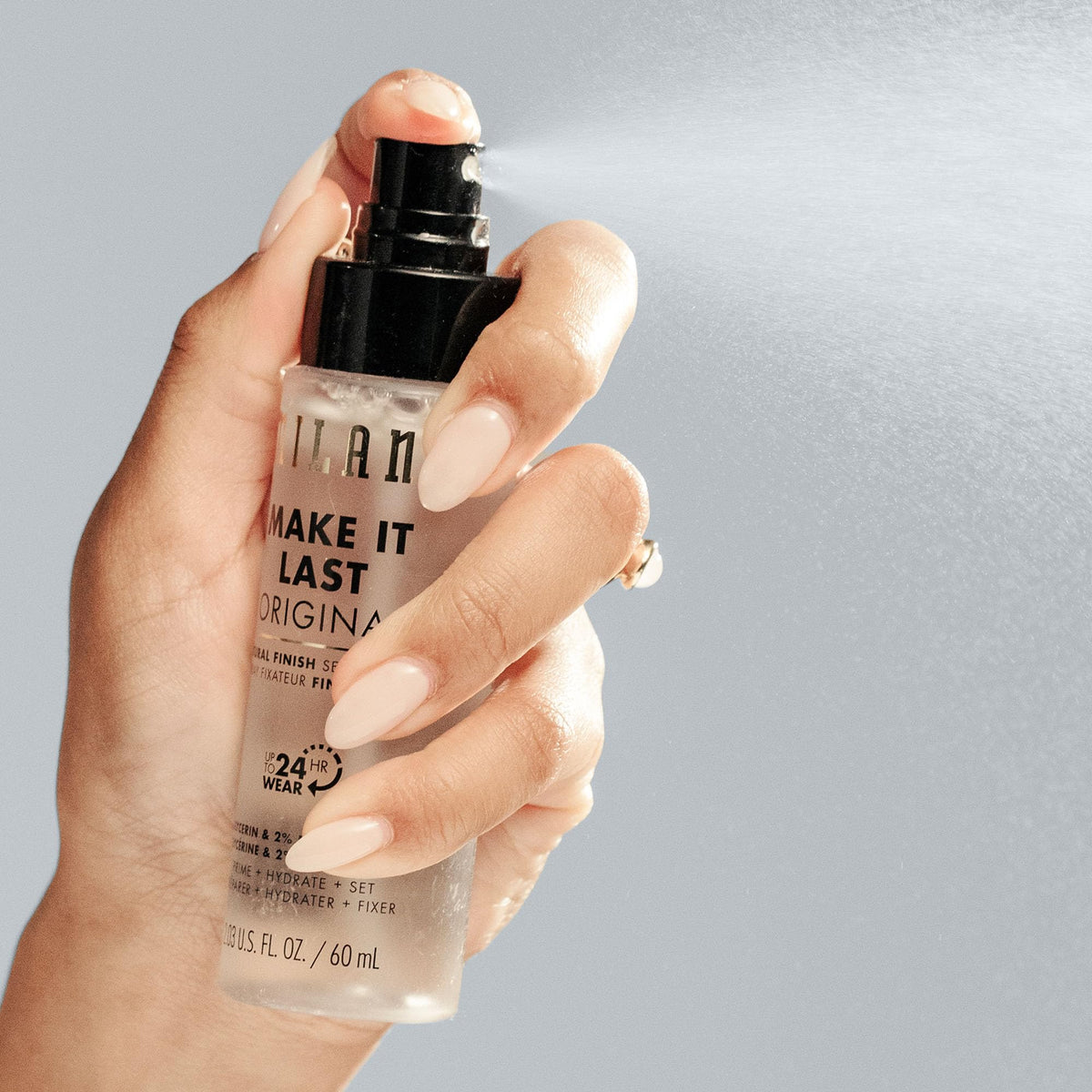 Milani being applied on model to prime and refresh makeup