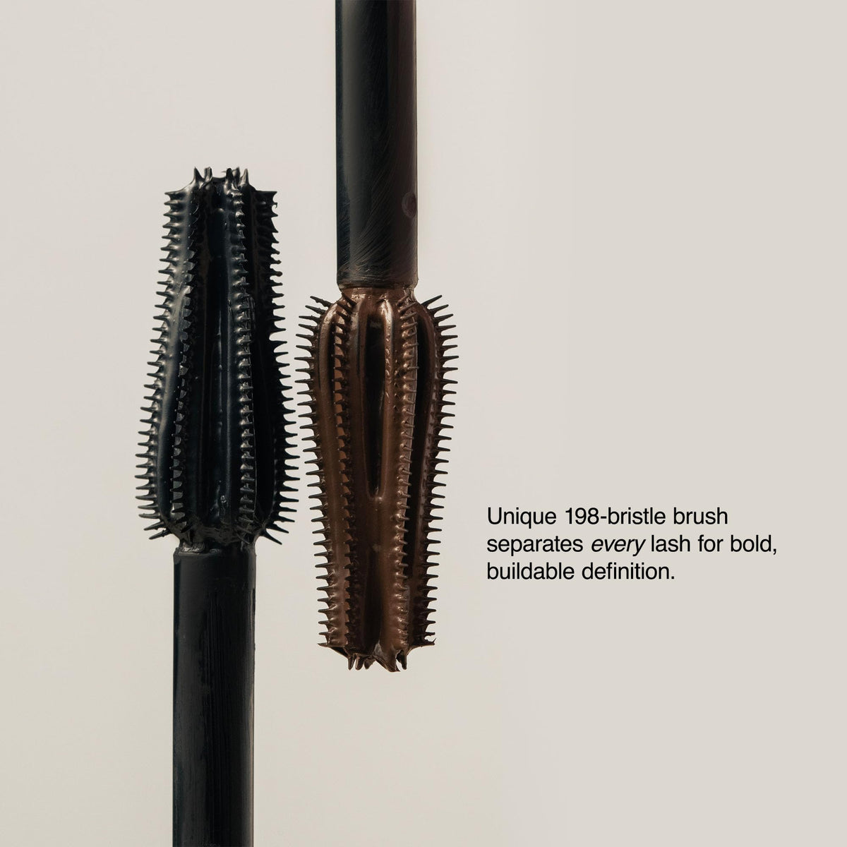 Milani mascara held in hand for scale showing compact travel-friendly size