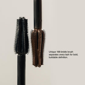 Milani mascara held in hand for scale showing compact travel-friendly size